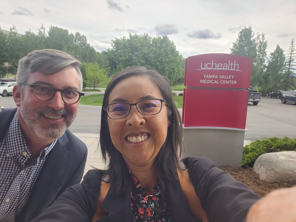 Adam Meyer, MD, and Darlene Tad-y, MD, smile together outside of the Yampa Valley Medical Center.