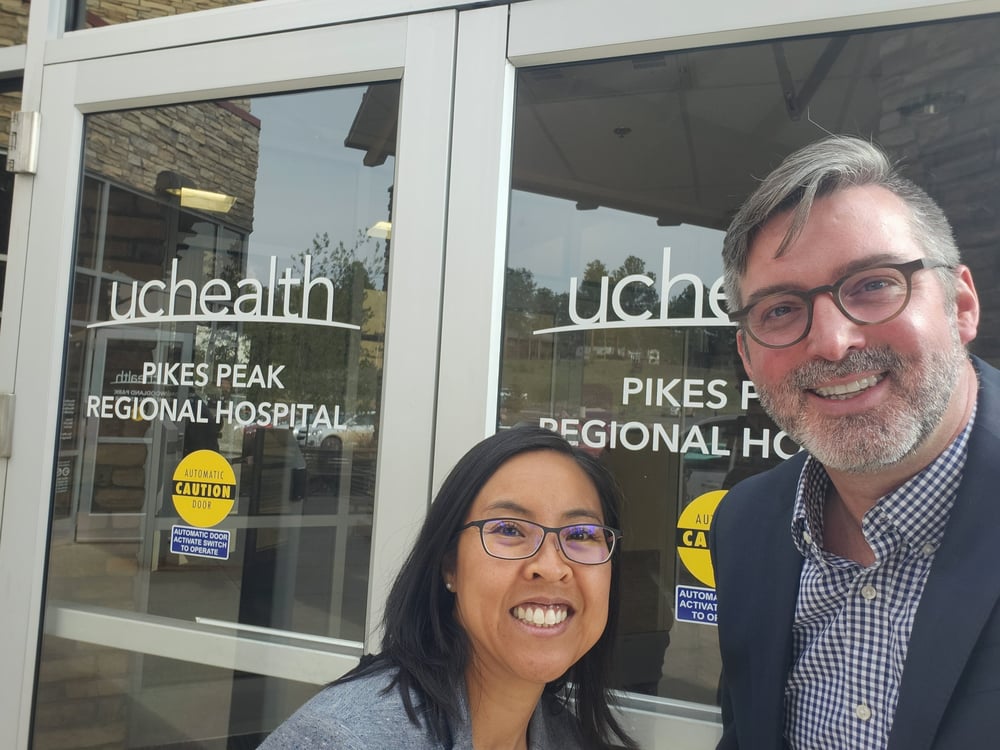 Darlene Tad-y, MD, and Adam Meyer, MD, smile together outside of Pikes Peak Regional Hospital.