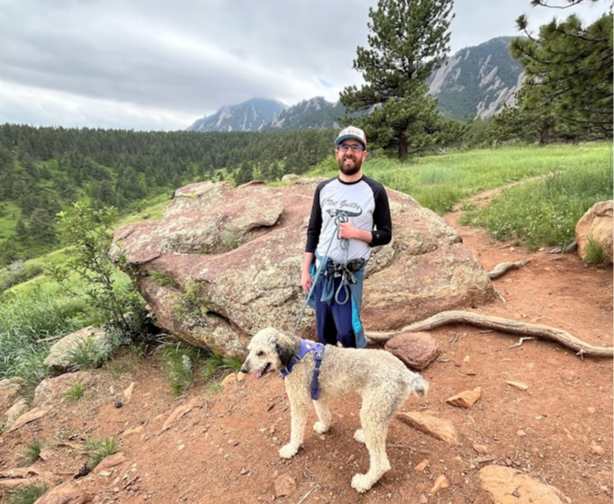 Bobby Click on a walk in the mountains with a dog.