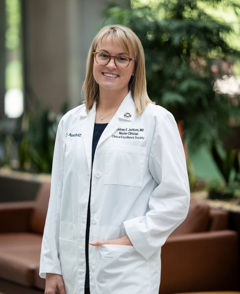 Whitney Jackson, MD, smiles while wearing her white coat at CU Anschutz.