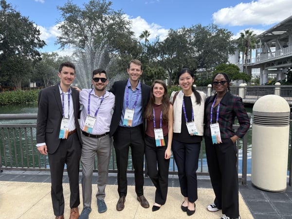 Six ophthalmology residents smile while standing outside.