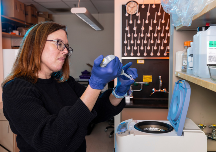 An ophthalmology researcher works in a lab.