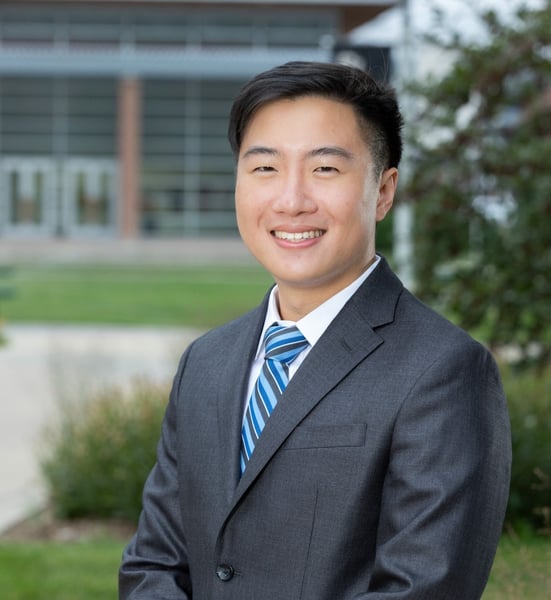Nicholas Tan, MD, smiles while standing at the CU Anschutz campus.