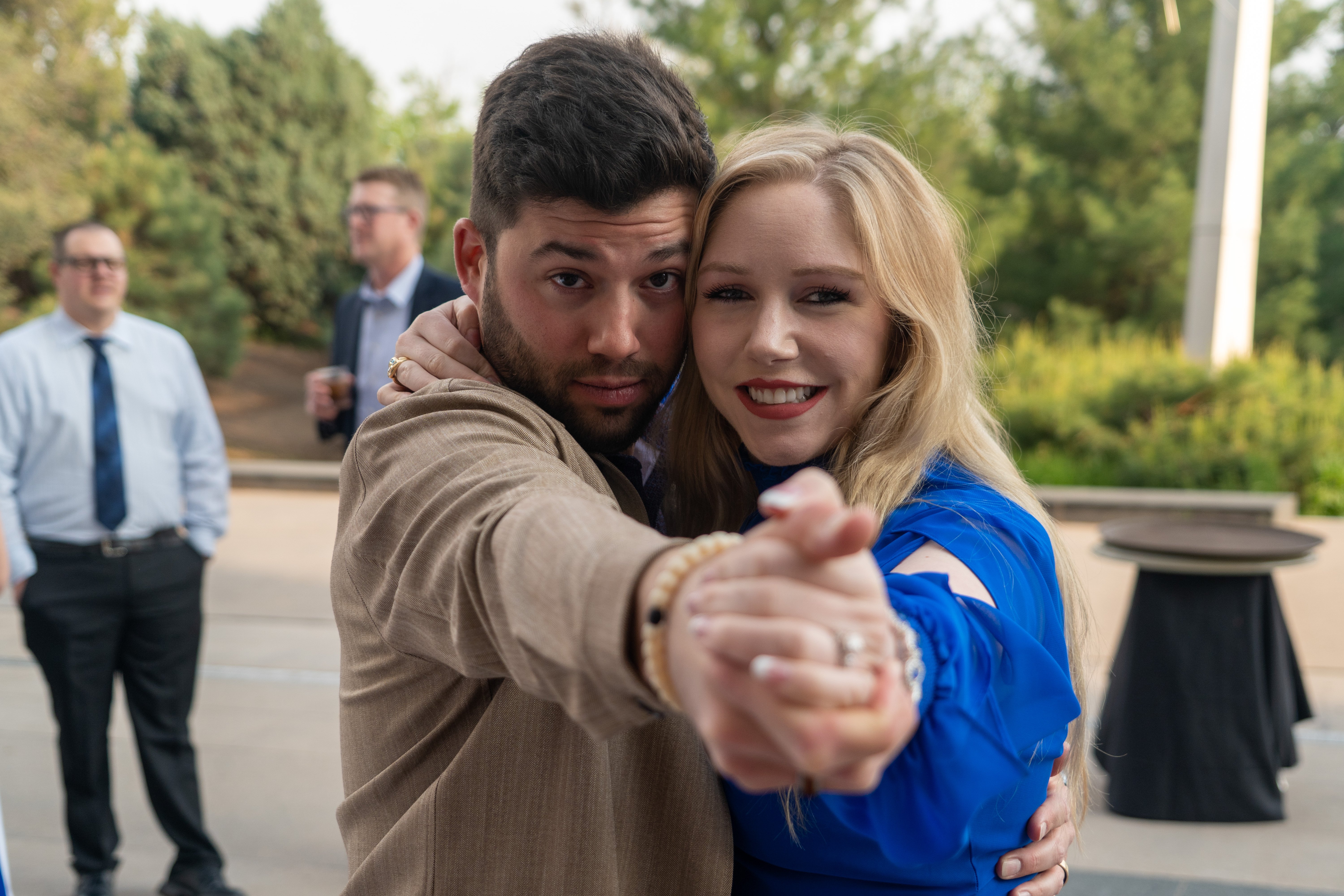 two people holding their hands together out towards the camera 