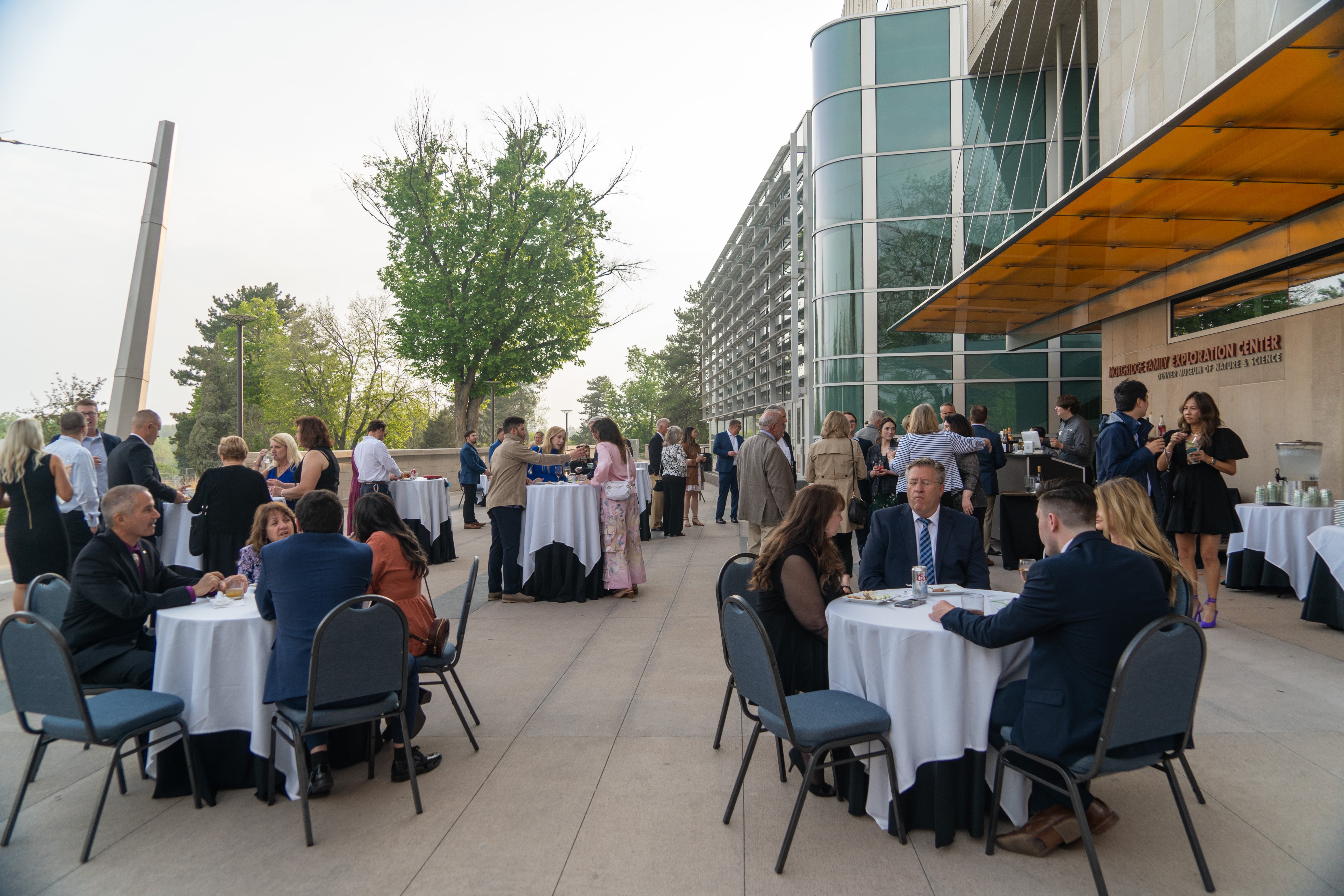 people at round tables during reception cocktail hour outside