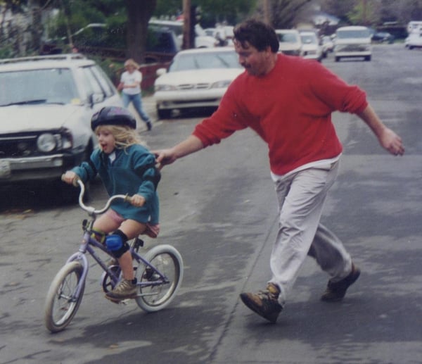 Ross's father teaching her how to ride a bike