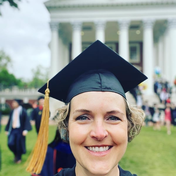 Emily Benton takes a selfie while wearing a graduation cap.