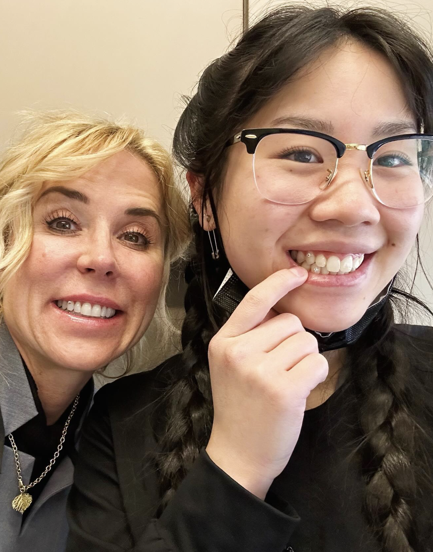 Madeline Geist smiles showing her tooth gems