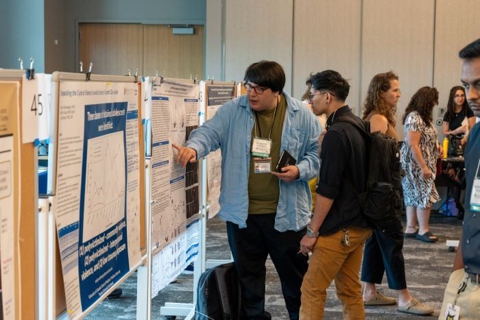 Poster presenter speaking with attendee