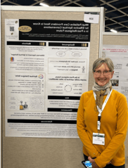 Kelly Arora in front of poster