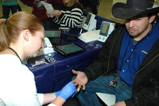 A visitor gets a glucose test at the National Western Stock Show.