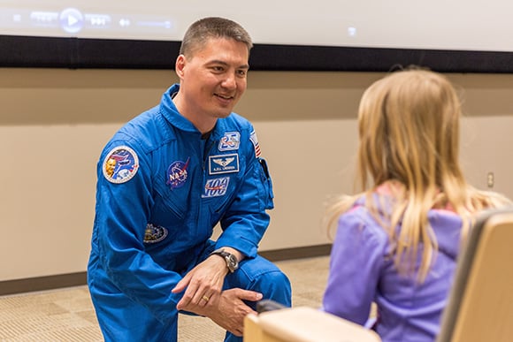 Kjell Lindgren gives child a NASA patch