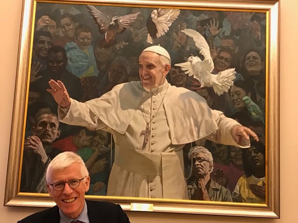 Jonathan Samet in front of painting of Pope Francis at the Vatican