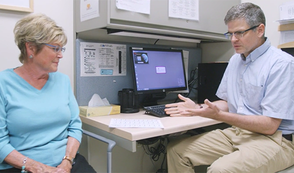 Dr. Kevin Deane talks with a patient about her rheumatoid arthritis