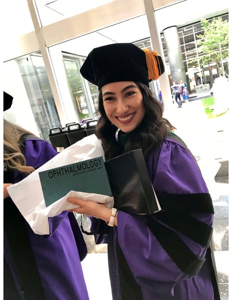 Jennifer Lopez, MD, wearing purple graduation regalia.