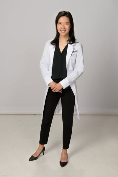 Julia Xia, MD, wearing her white coat.