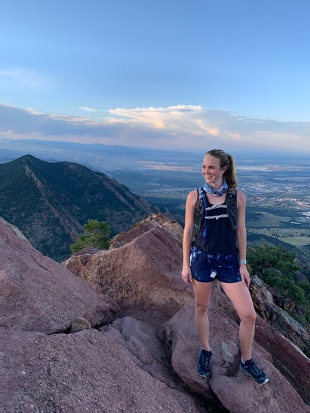 Madeline Quigley summits during a trail run.