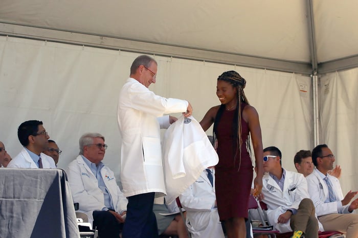 Arike Coker accepts her white coat at the Matriculation Ceremony on July 24, 2026.