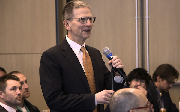 McIntyre at a microphone