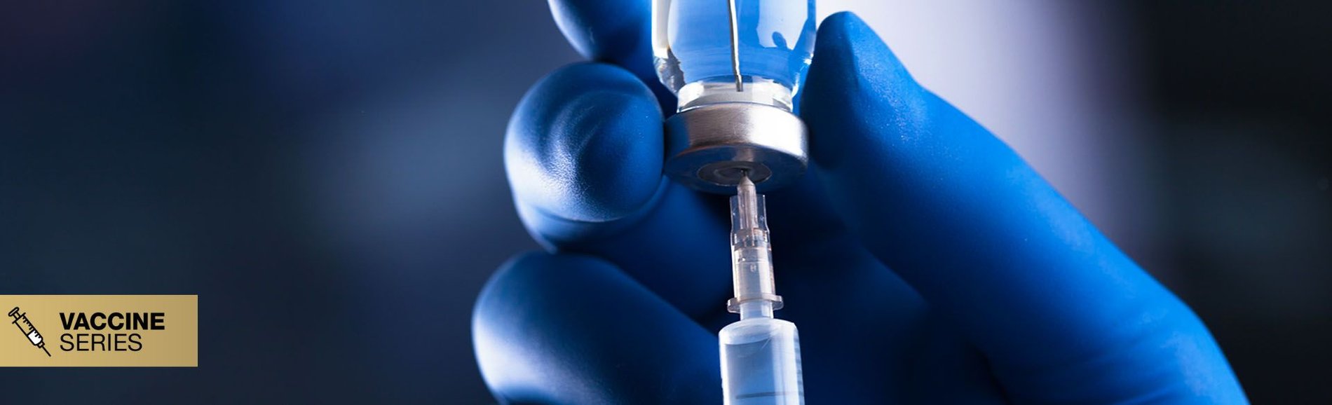 Blue-gloved hand extracting vaccine via needle from vial