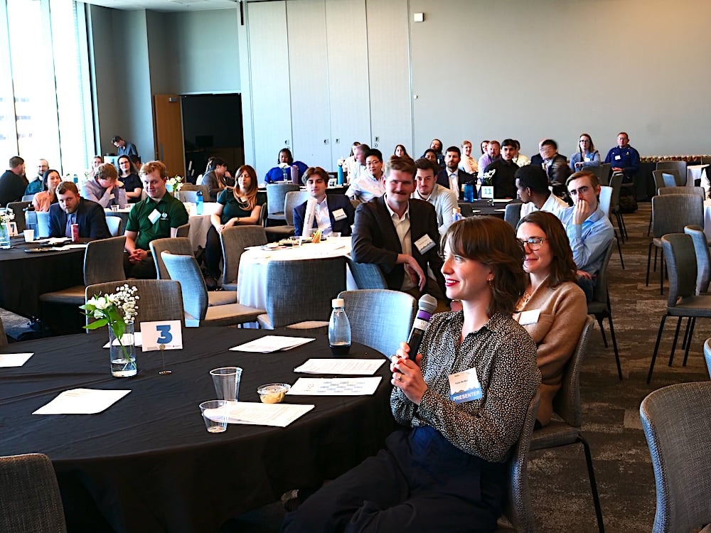 Attendee asks question.