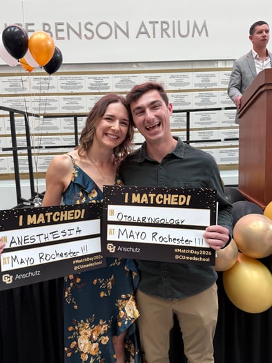 Kimberly Christnacht smiles with Ethan Moore on Match Day at CU Anschutz. They both hold up signs saying they matched into residency programs at Mayo Clinic in Rochester, Minnesota.