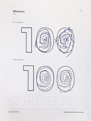 On a piece of paper, there are two large drawings of 100. At the top of the paper, a person drew spirals within the zeros of 100. These spirals are wobbly. At the bottom of the paper, there are similar spirals drawn within the zeros of 100, but these spirals are more smooth.