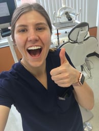Sheaffer Skadsen, DDS '21, in dental clinic smiling and giving a thumbs up