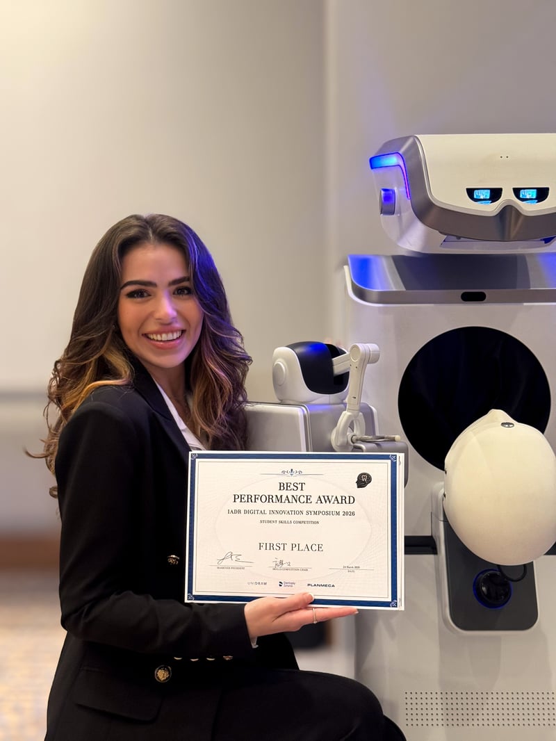 Diana Torosyan with Best Performance Award in front of dental haptics simulation machine