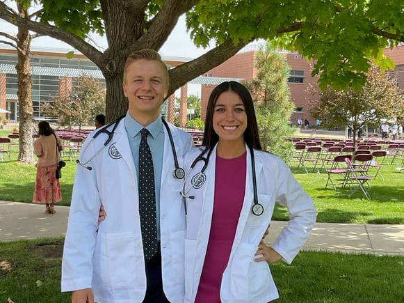 A man and woman in white coats and stethoscopes.