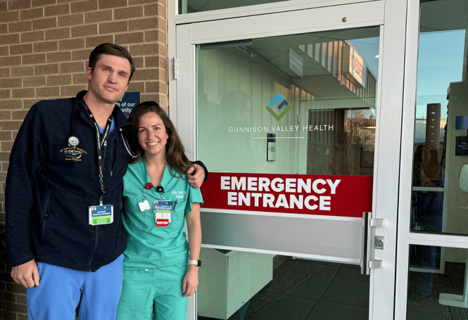 Student Michael Nocek and Dr. Kelly Stewart pose for a photo in front of the ED entrance at Gunnison Valley Health.