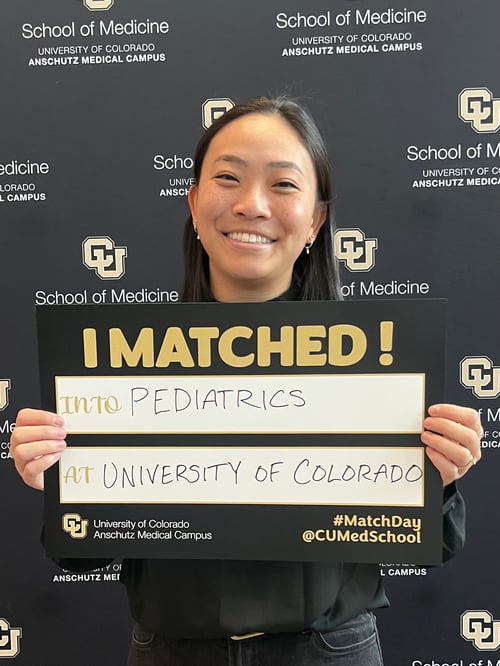 Branscomb holding up a sign with her pediatrics placement at CU on Match Day 2024.