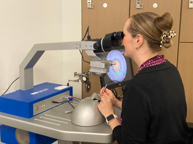 Deidre St. Peter, MD, practices a surgical simulation on a machine.