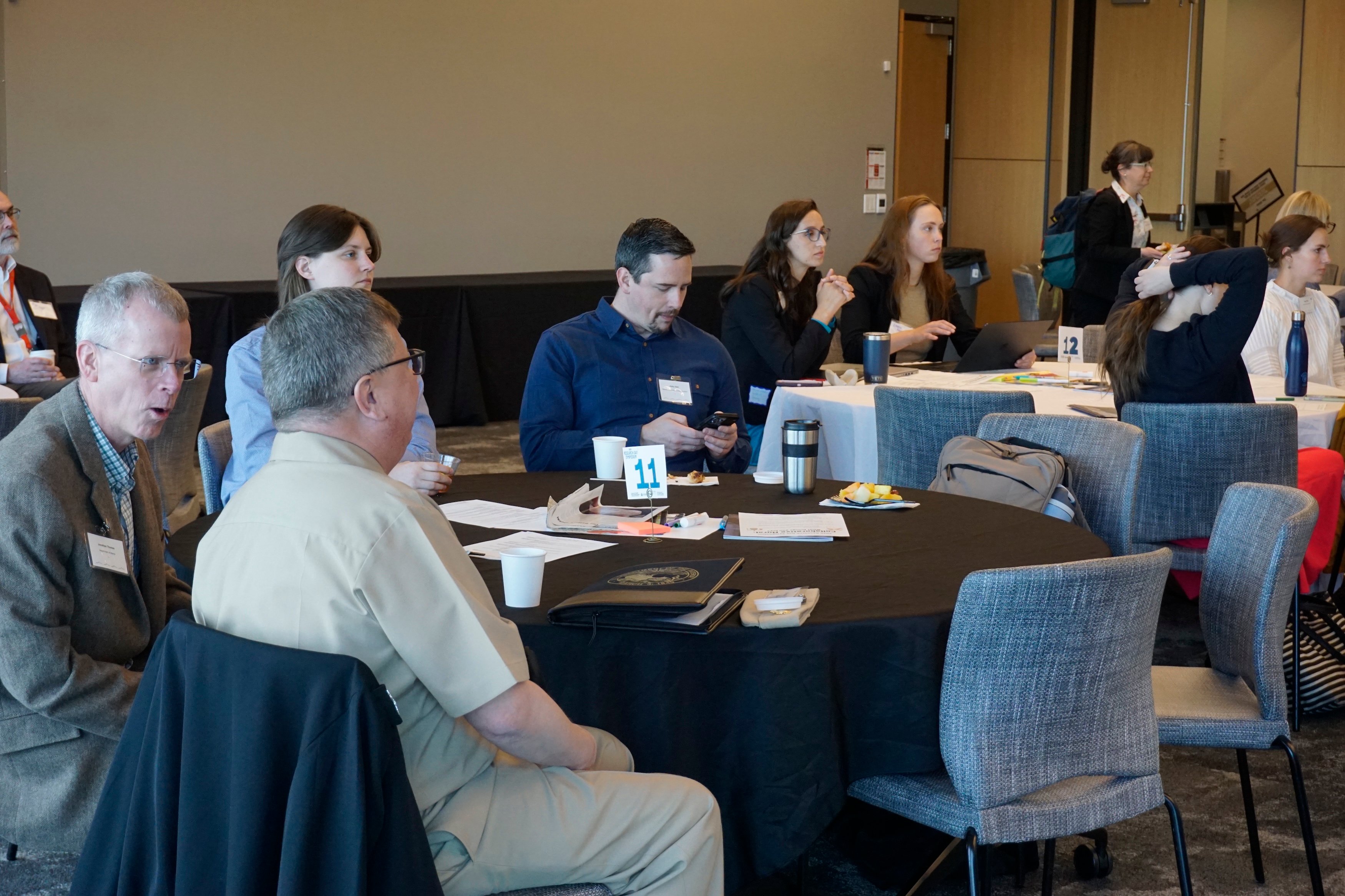 Attendees discussing at a table.