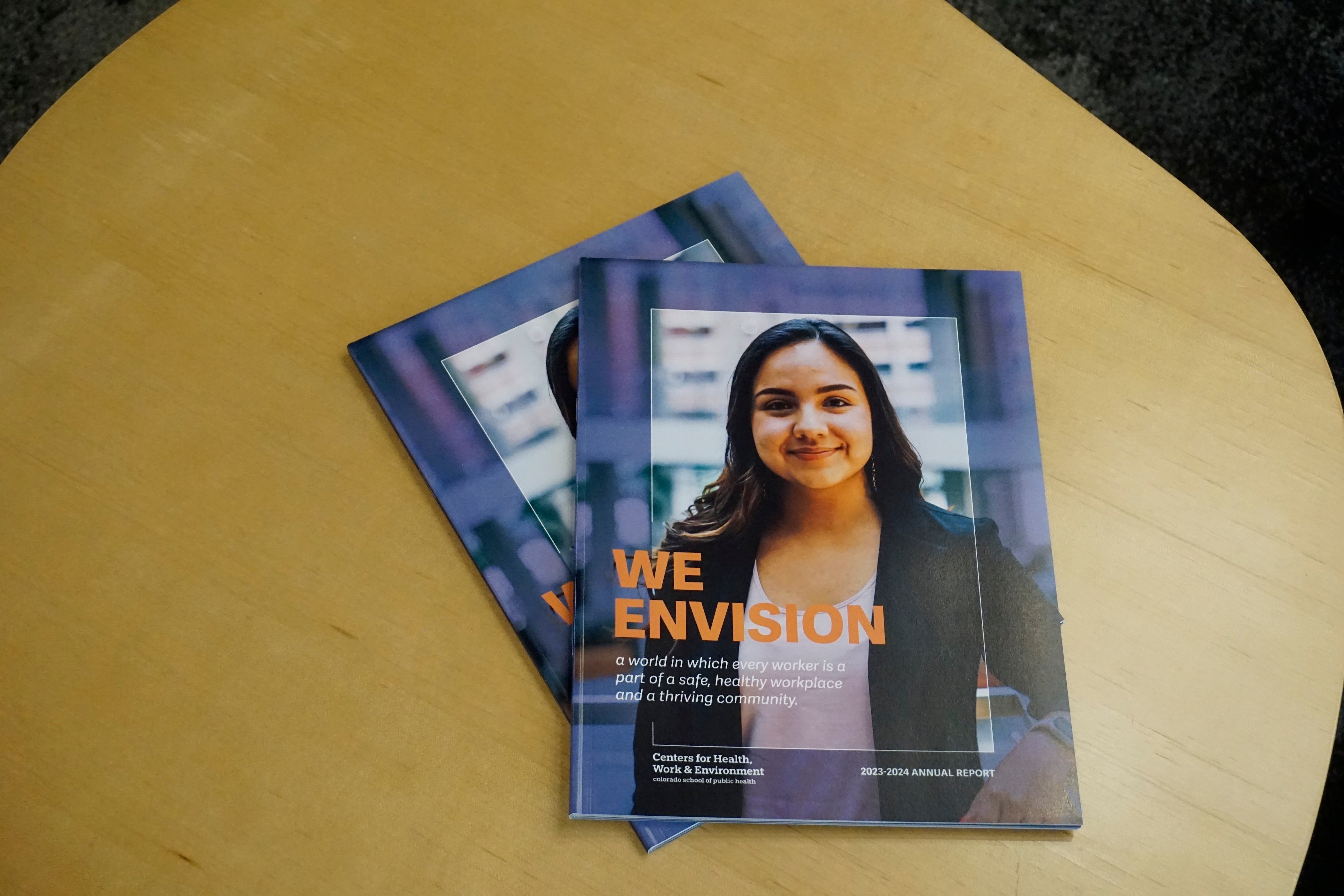 Picture of the CHWE Annual Report Magazines on a table.