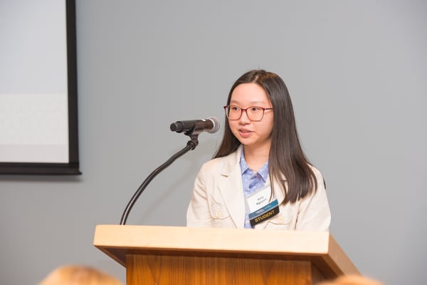 amy nguyen speaking at podium