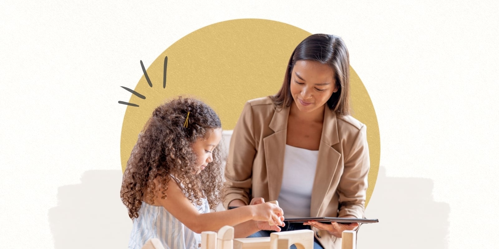 A psychiatrist sits with a child as she plays with wooden blocks. 