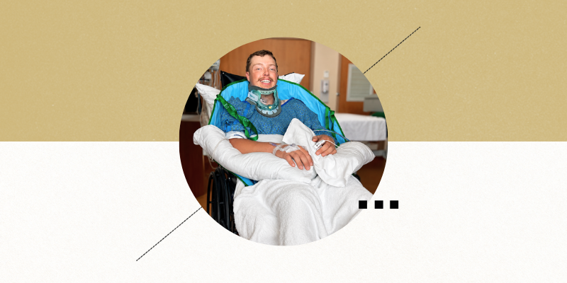 Garrett sits in a chair in a hospital room with a neck brace, smiling. 