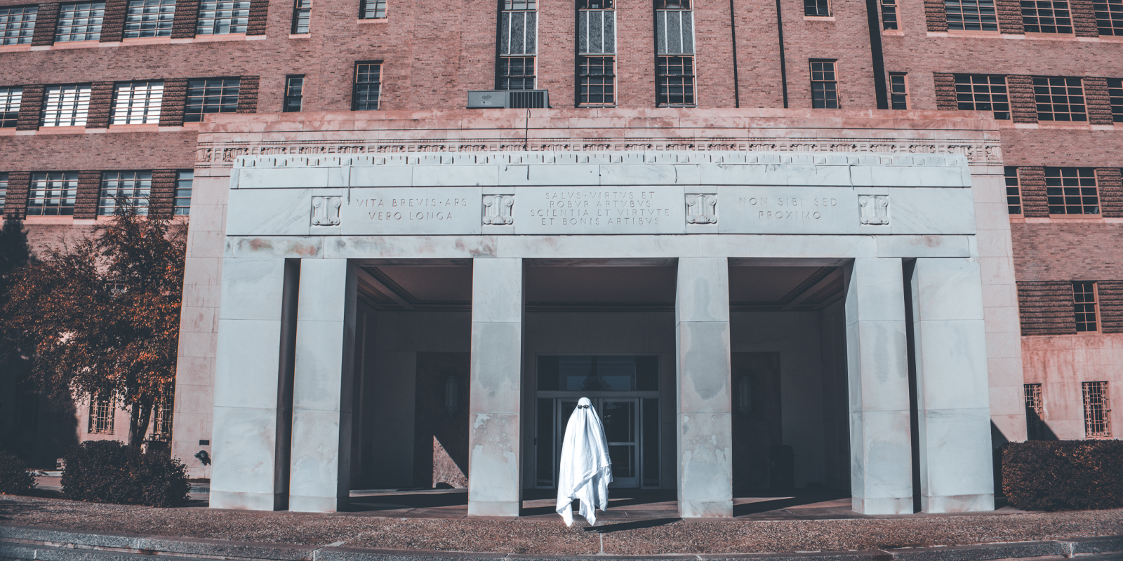 The main entrance to Fitzsimons Building with a silly, sunglass clad ghost