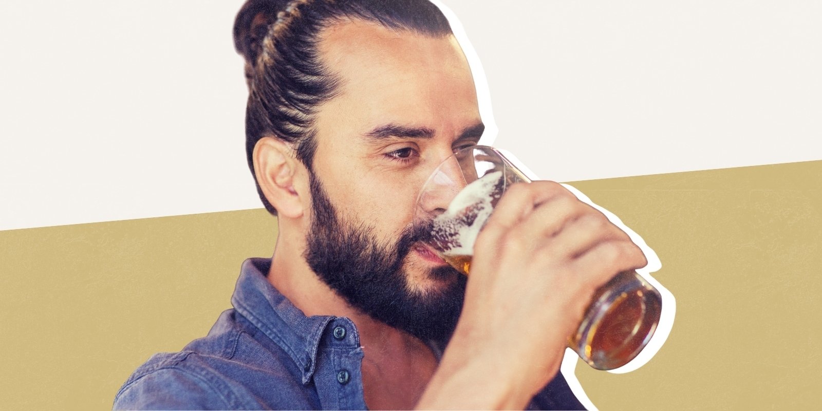 A bearded man drinks a beer from a pint glass. 