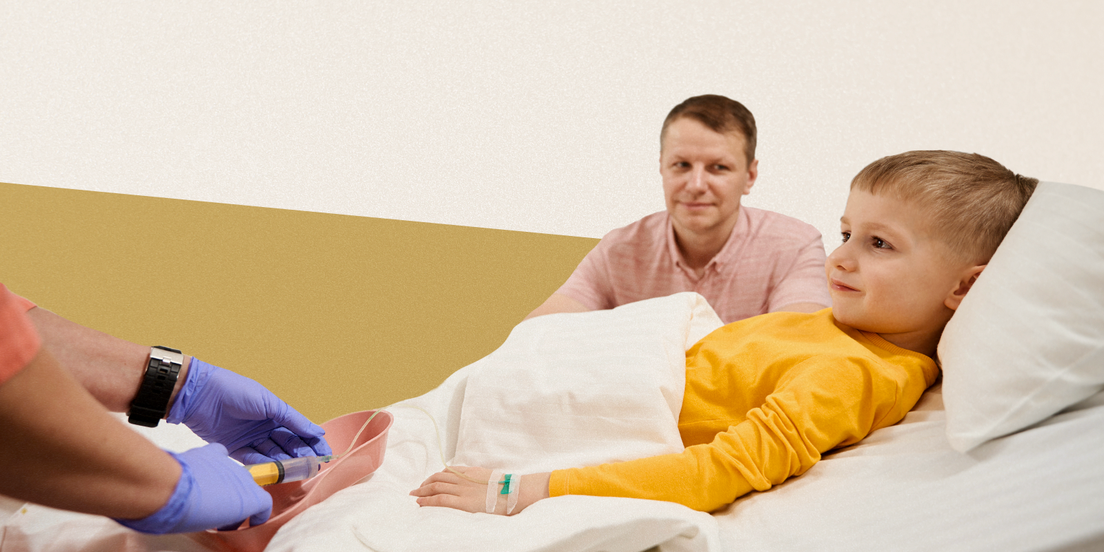 A child lies under a weighted blanket while his parent and a nurse look on.