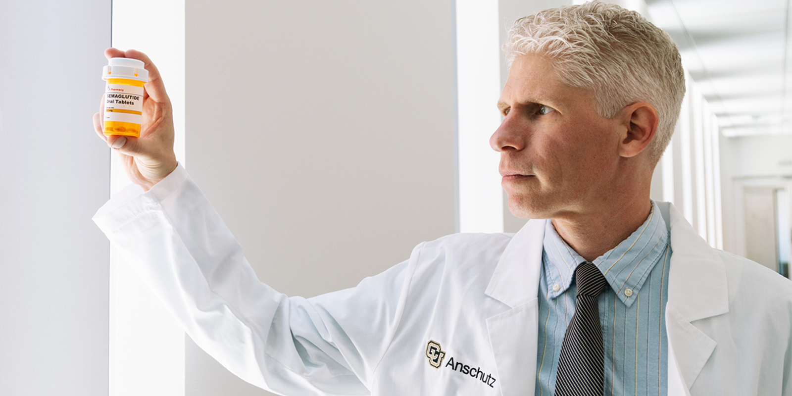 Joseph Schacht, PhD, holds up a bottle of semaglutide at CU Anschutz 