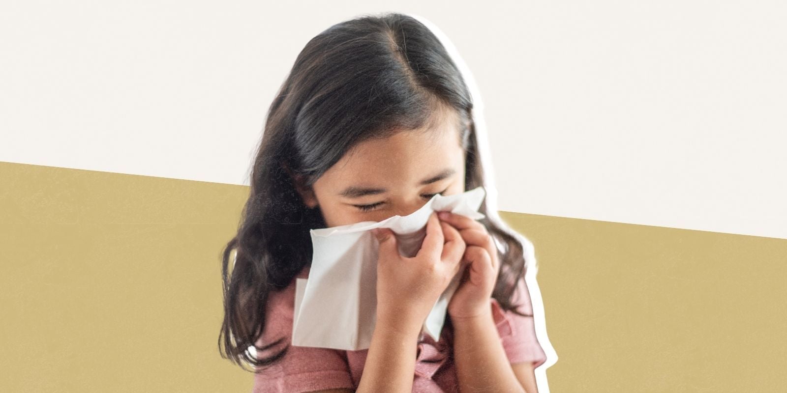A young girl with long dark hair covers in nose and mouth with a tissue.