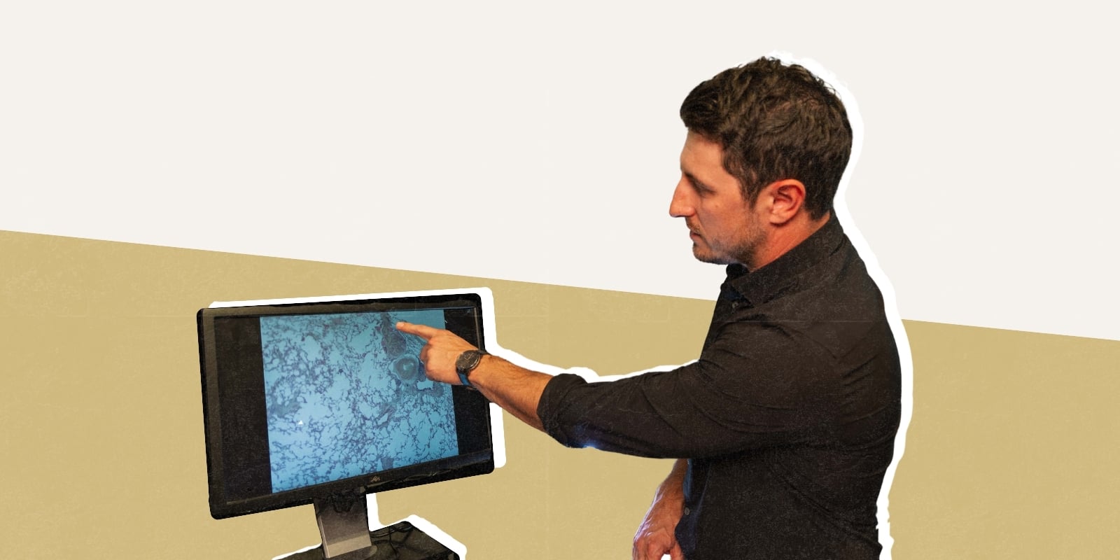 Photo of Andrew Bubak pointing to a computer screen that displays nerves 