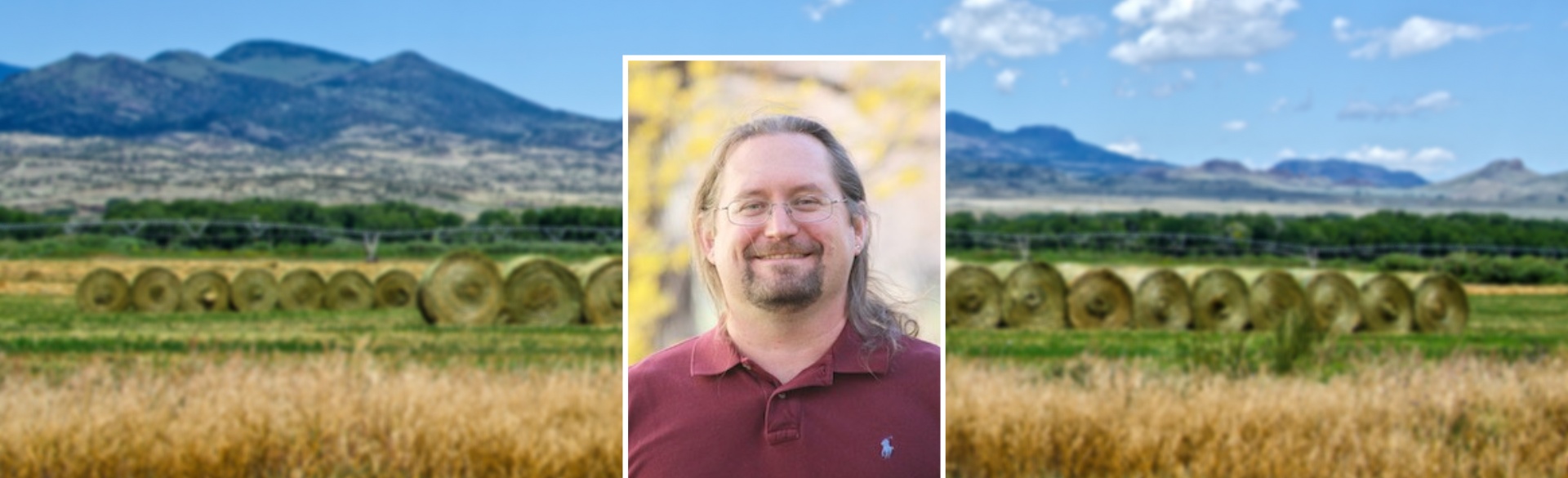 Man smiling in headshot on background of Colorado mountains