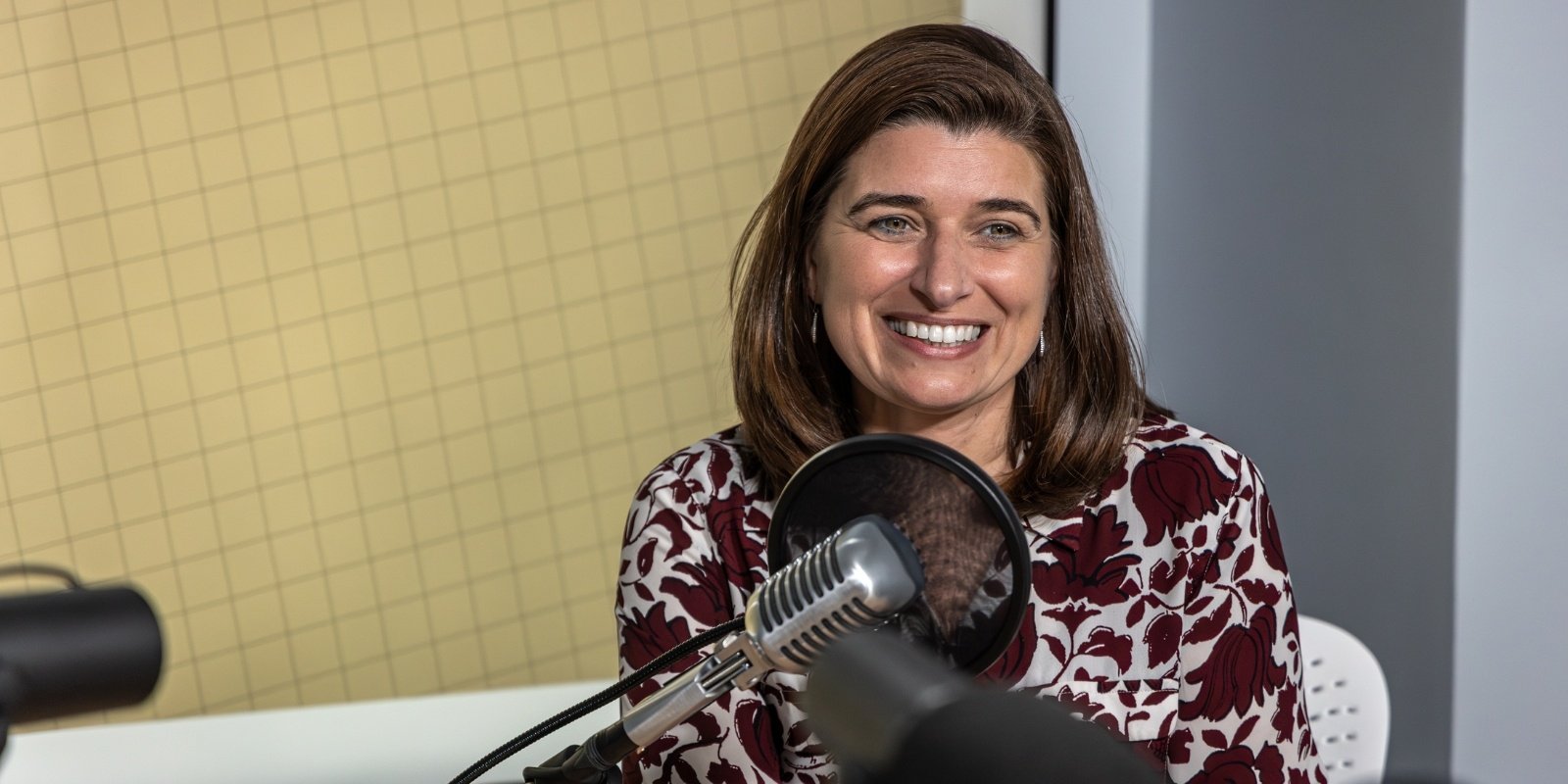 Valeria Canto-Soler, PhD smiling in front of microphone