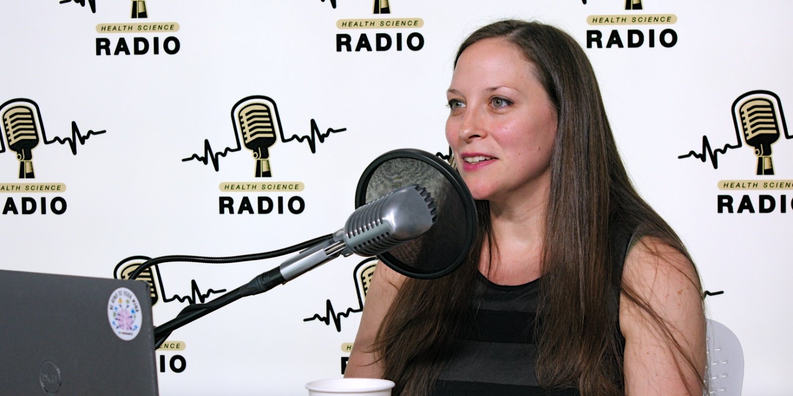 Mandy Doria speaking in front of a microphone