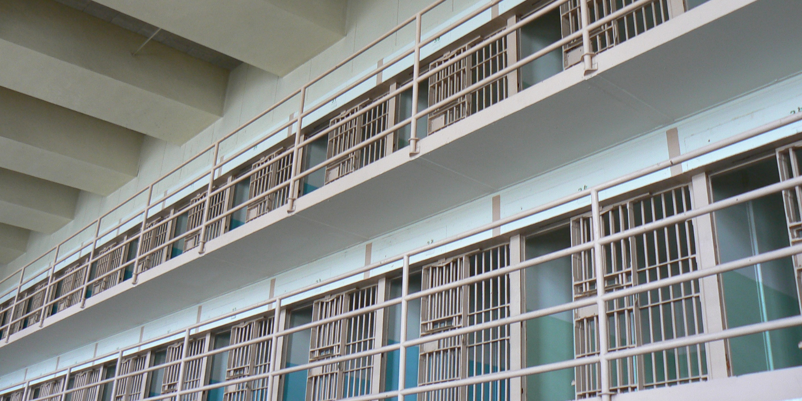 Rows of jail cells with doors open