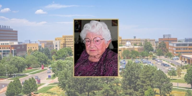 Headshot of Helen Morris, MD against background of CU Anschutz campus aerial view facing Fitzsimmons.