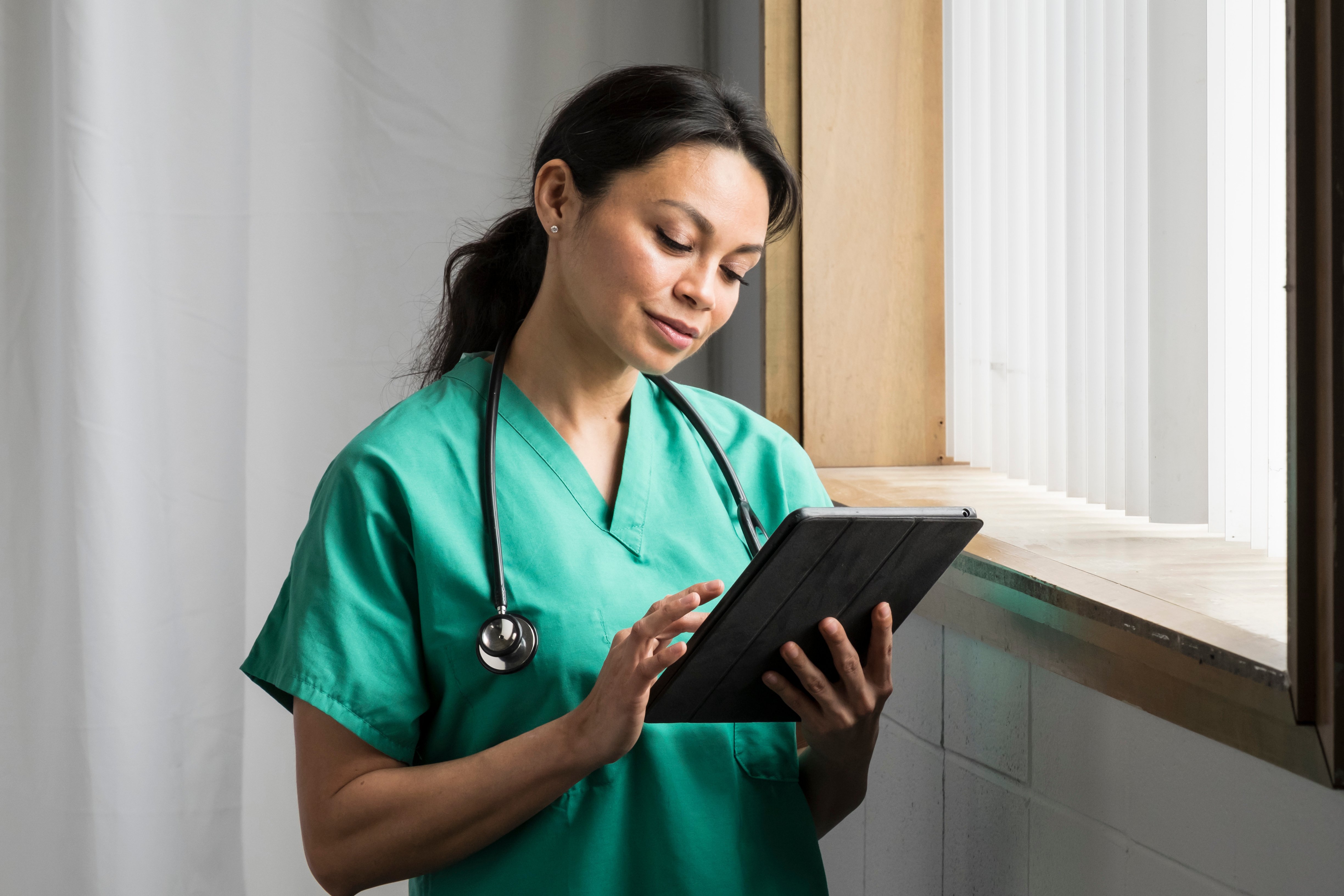 nurse looking at a tablet